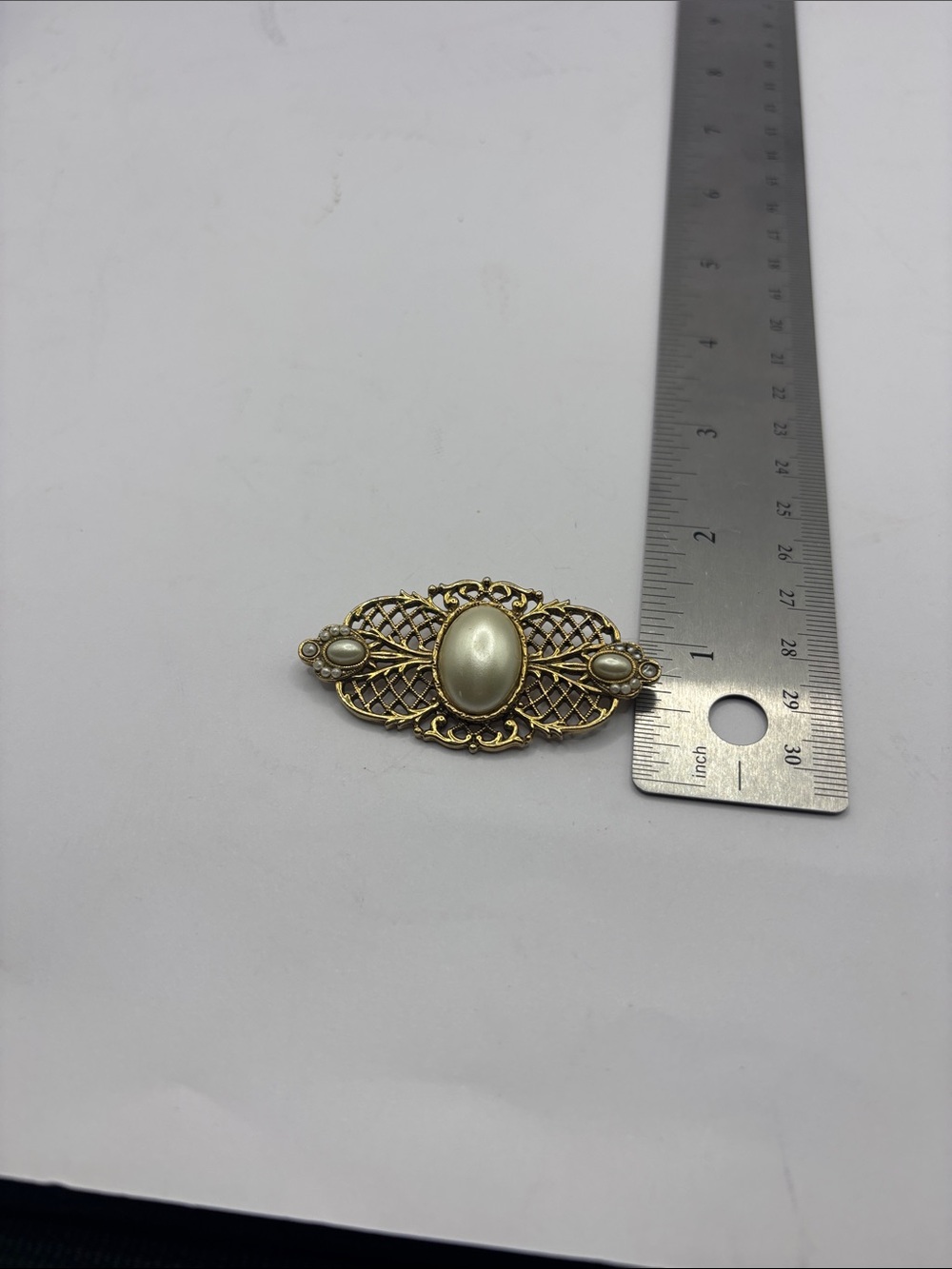 Vintage-Inspired Gold Tone Brooch with Cream Cabochon